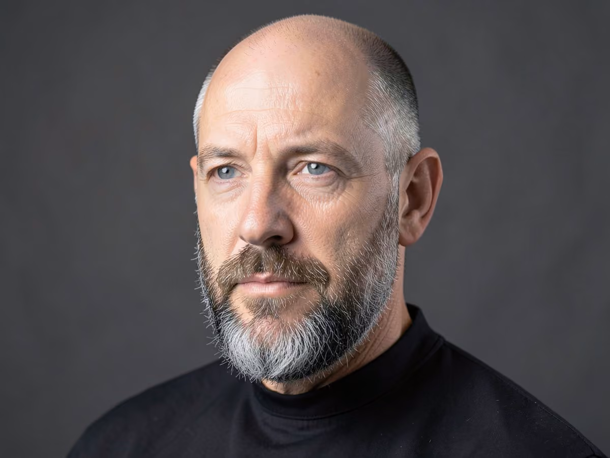 Man with a bald with salt and pepper beard haircut