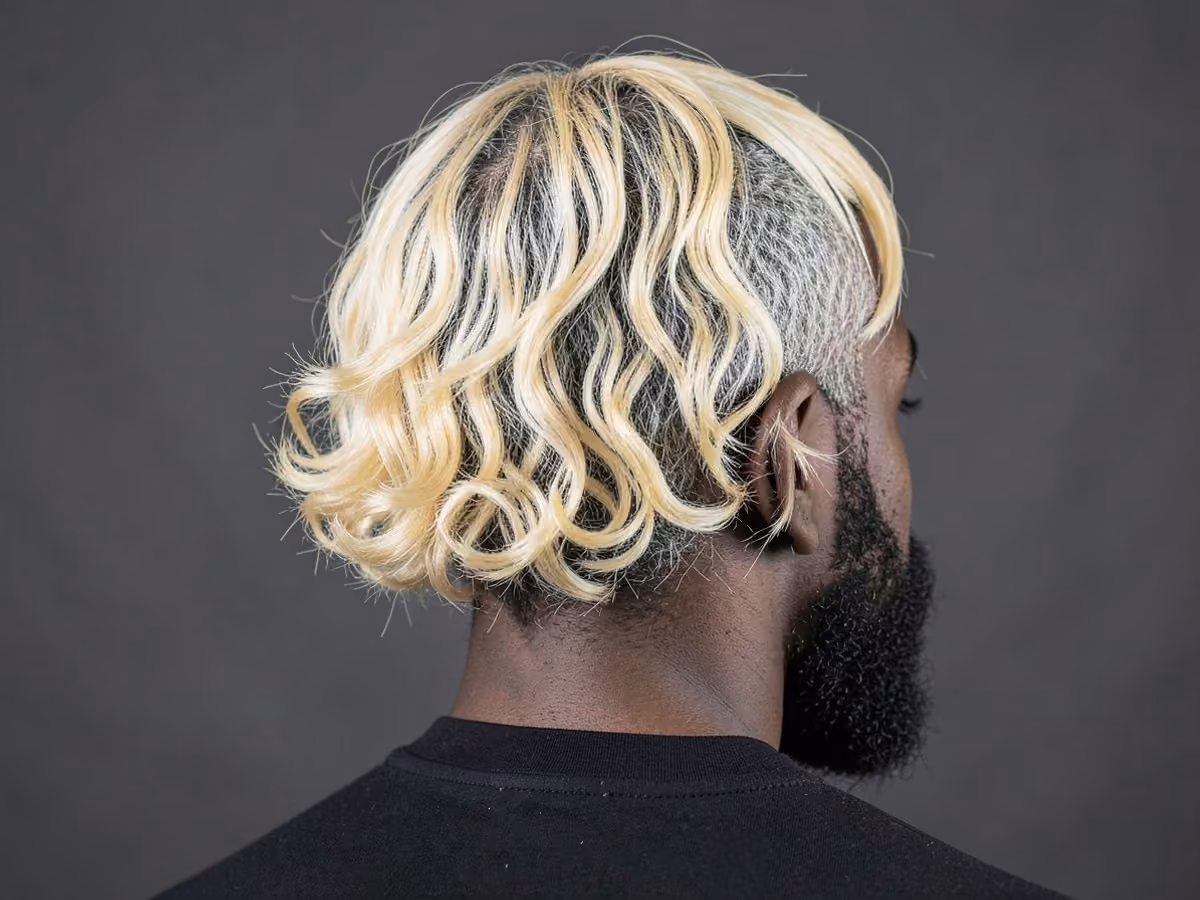 Man with a blonde baseball flow