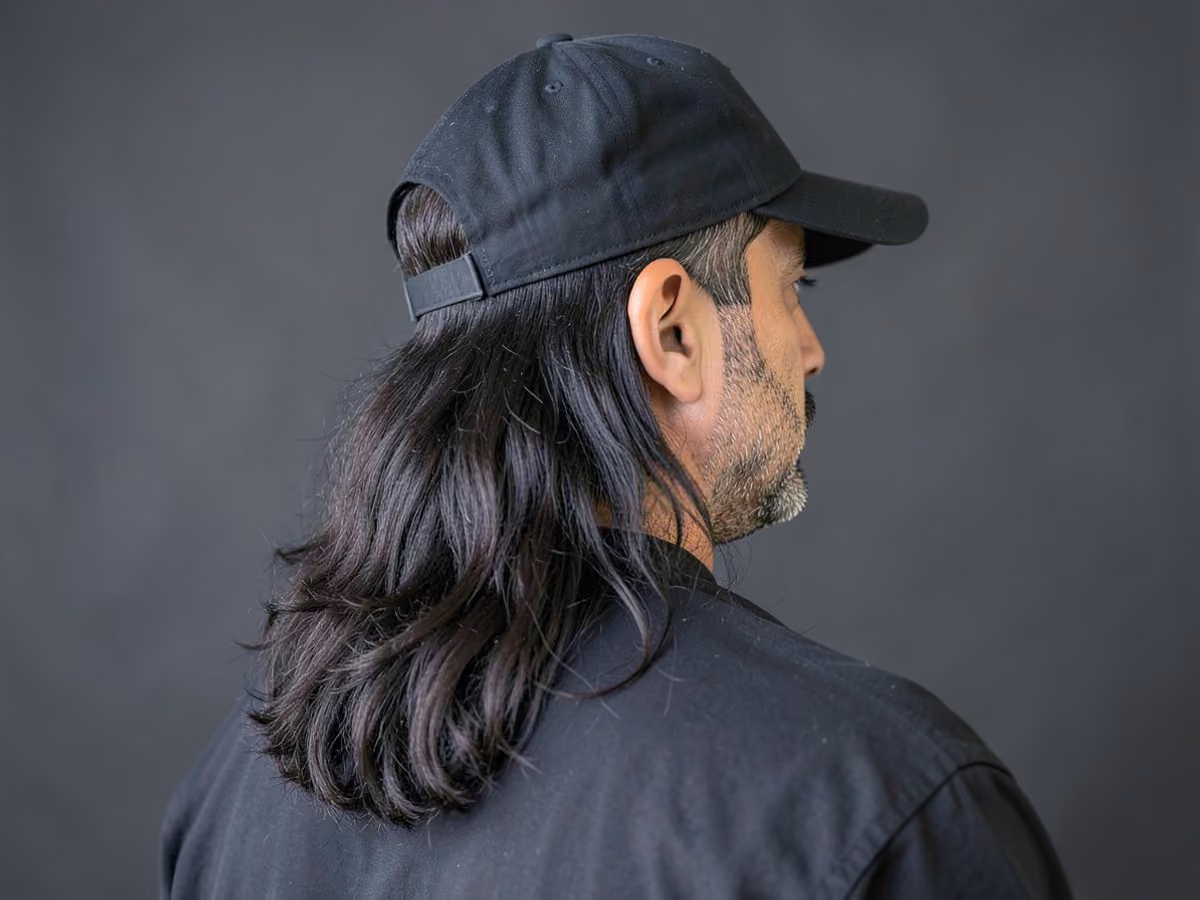 Man with a long baseball flow