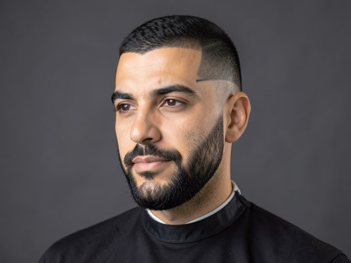 Man with a beard fade with hard cheek line