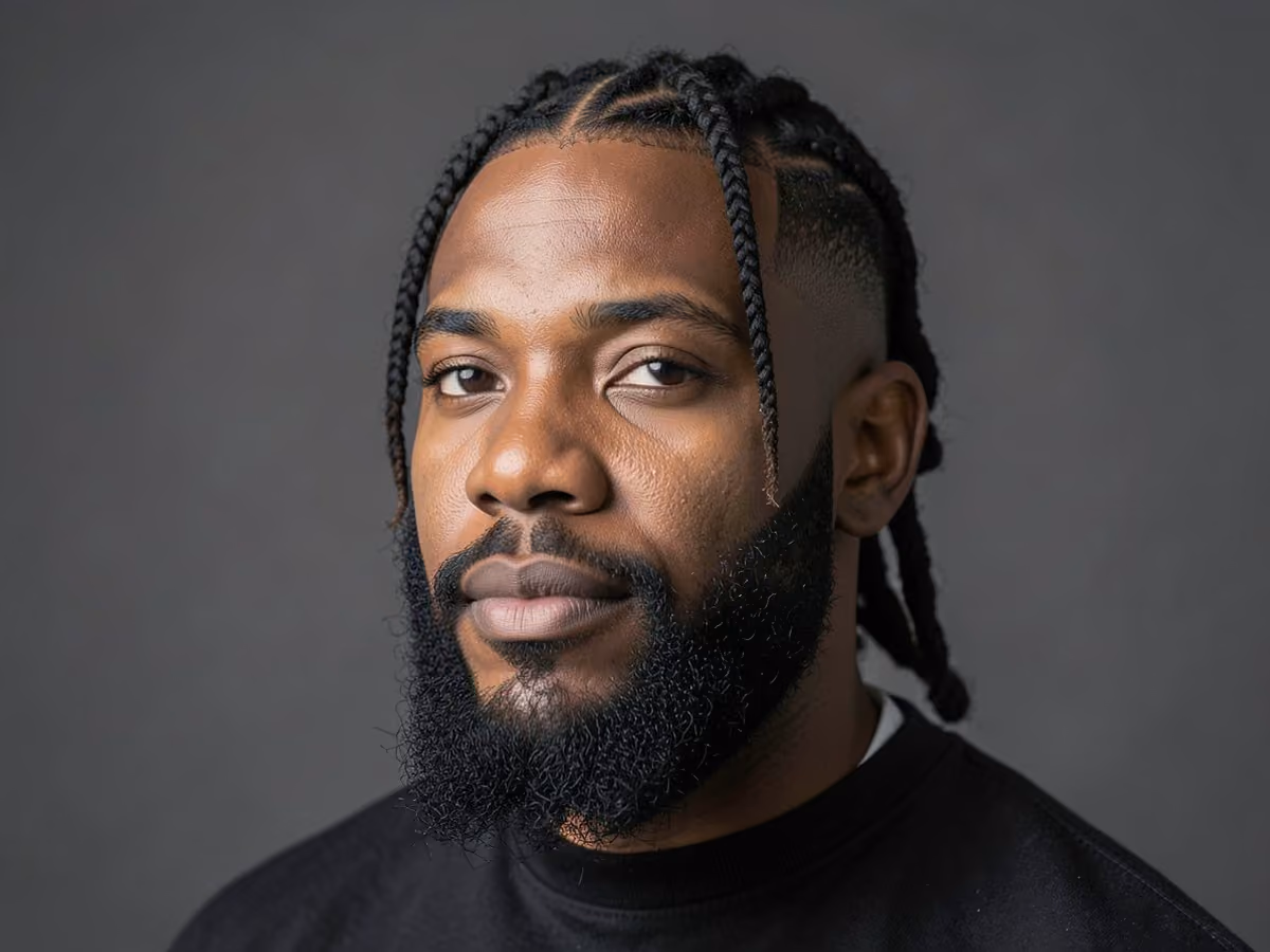 Man with a twists with beard fade