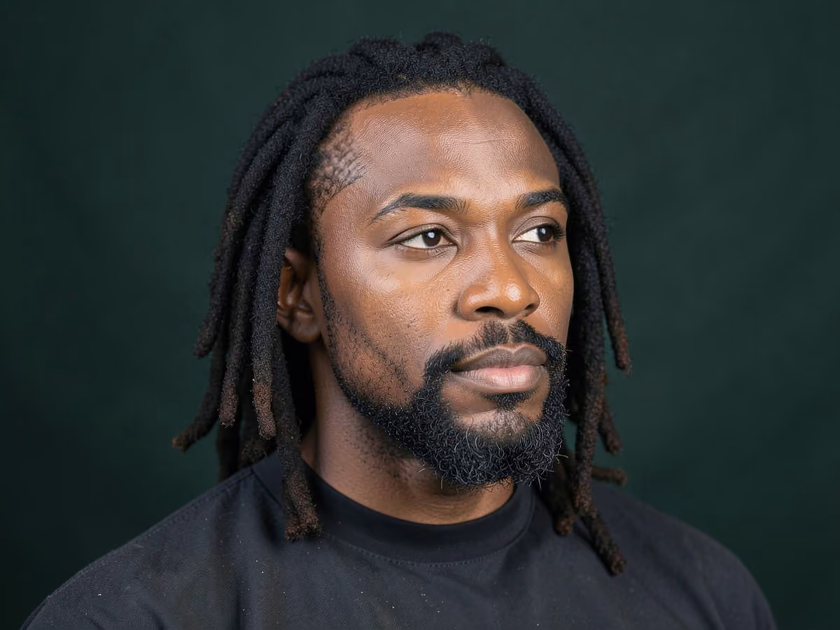 Man with a locs with short boxed beard haircut