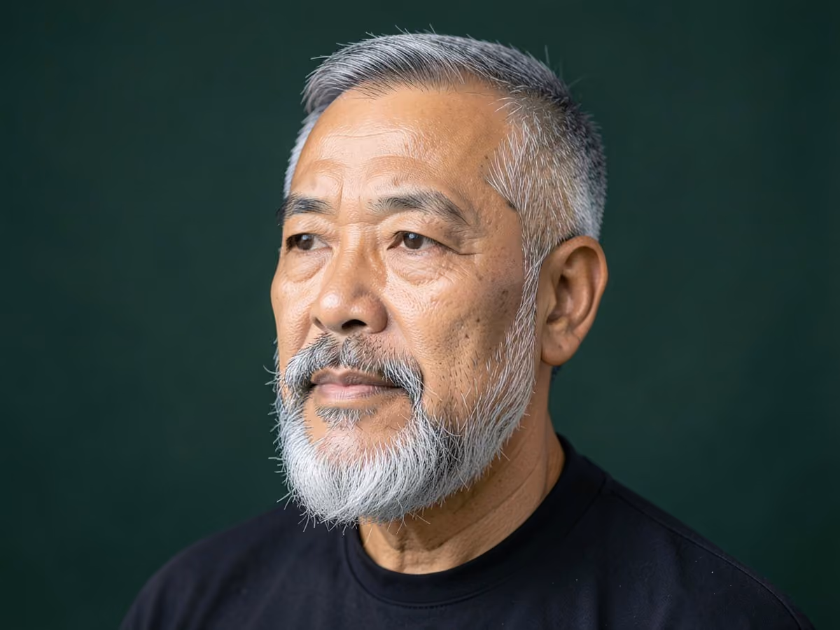 Man with a full beard with sharp cheek line haircut