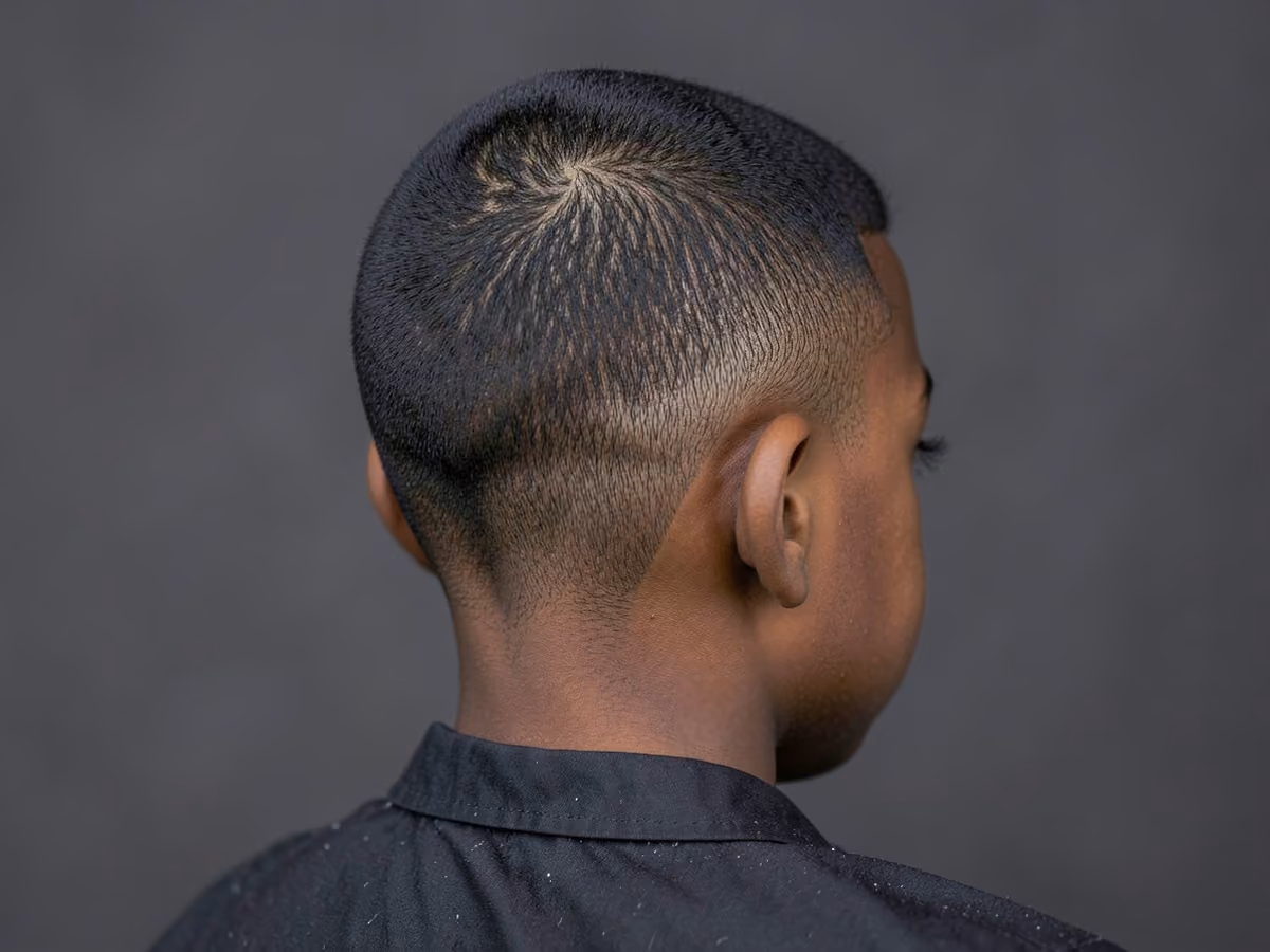 Boy with a black boys dress code taper haircut
