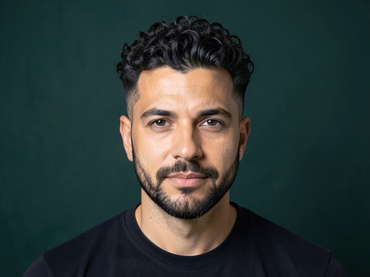 Man with a curly blowout taper haircut