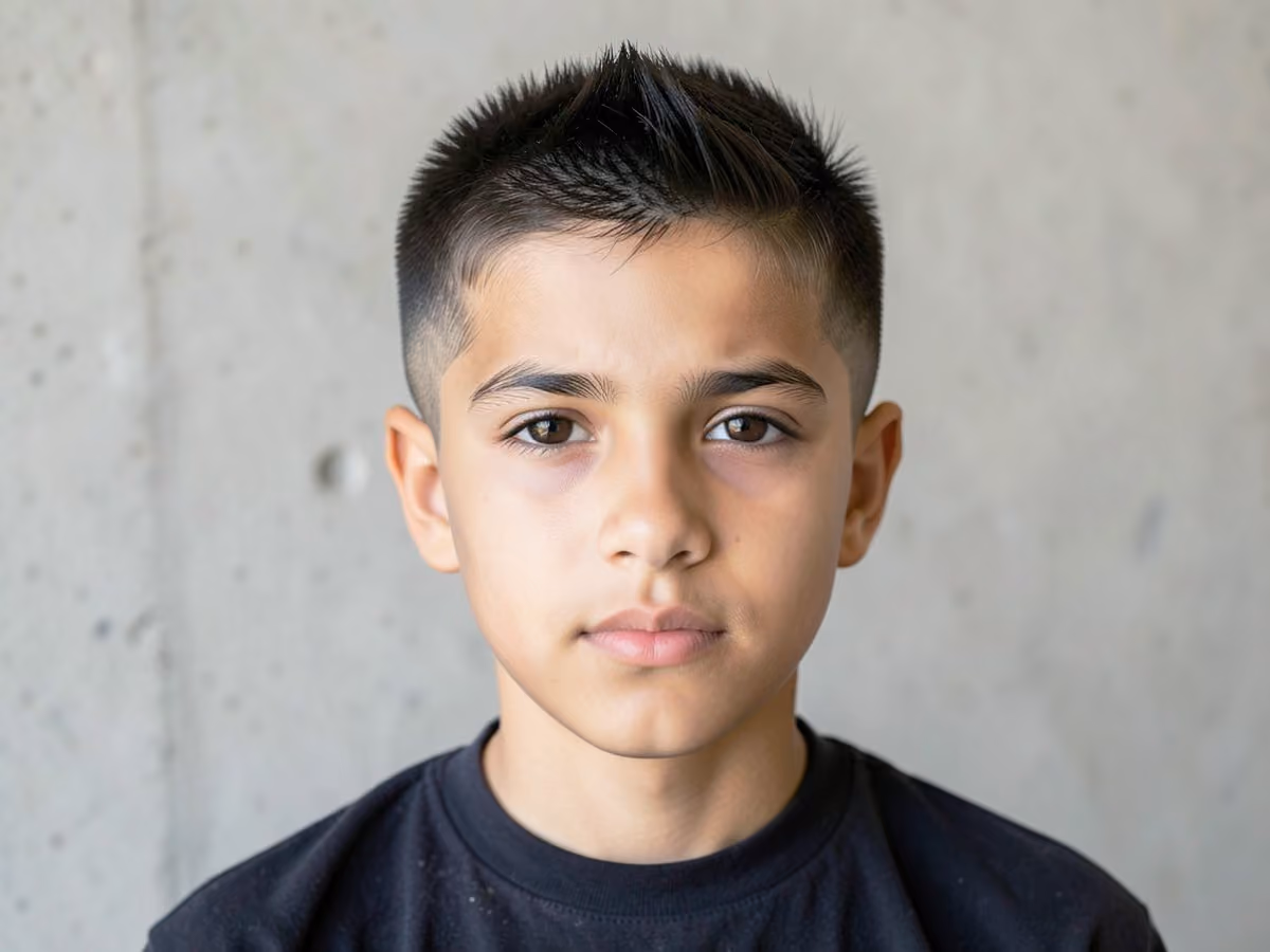 Boy with a boys brush cut fade