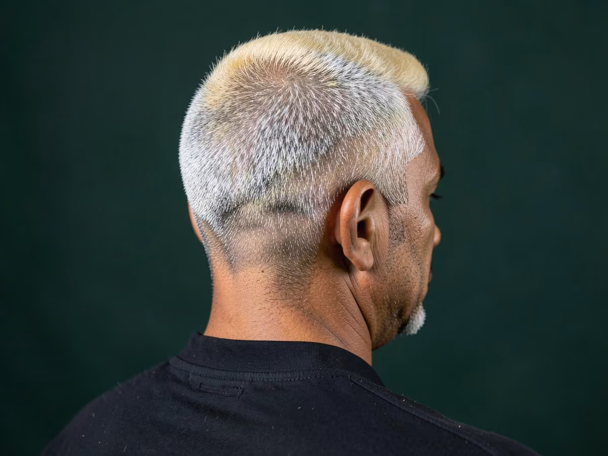 Man with a brad pitt highlighted crew cut