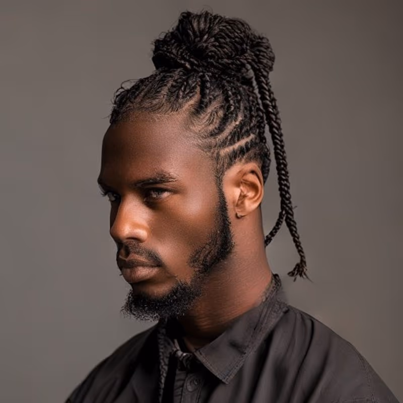 Box Braids Man Bun hairstyle for men 2026 — Braids for Men variation, best for Box braids tied up and off the face, modern barbering by Master Stylist Jessica Hamilton