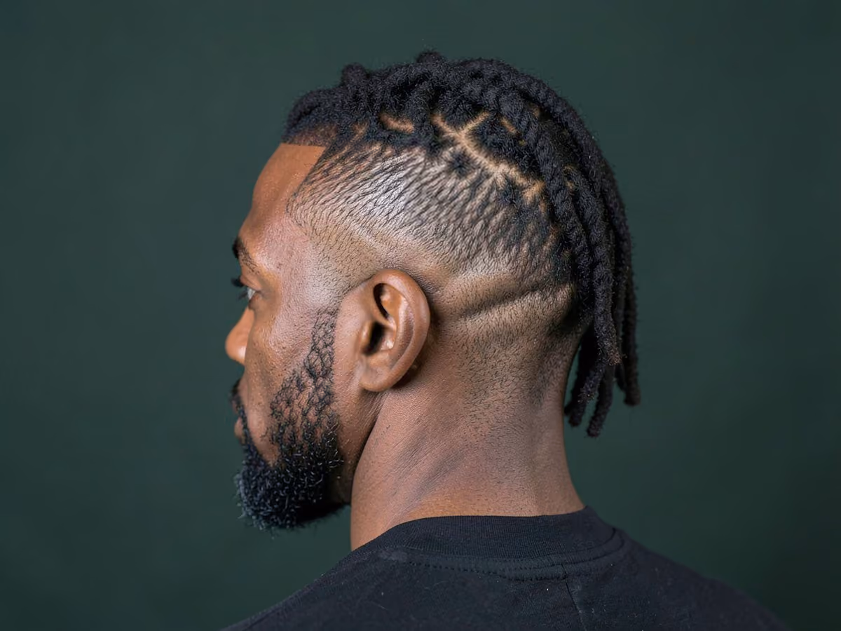 Man with a burst fade with locs
