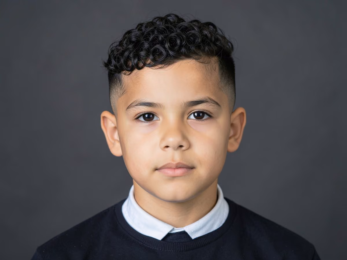 Boy with a boys curly fade