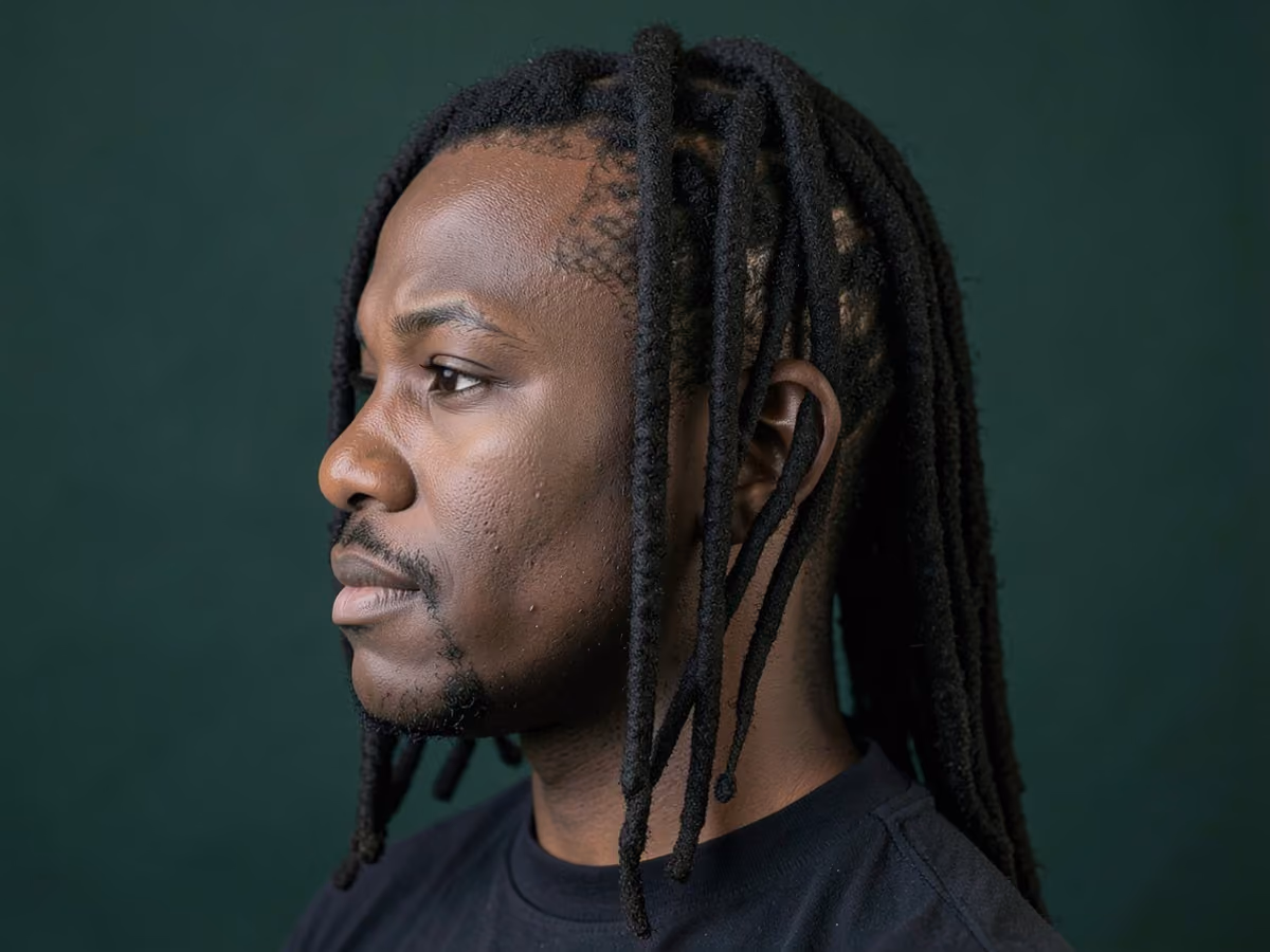 Man with a middle part locs