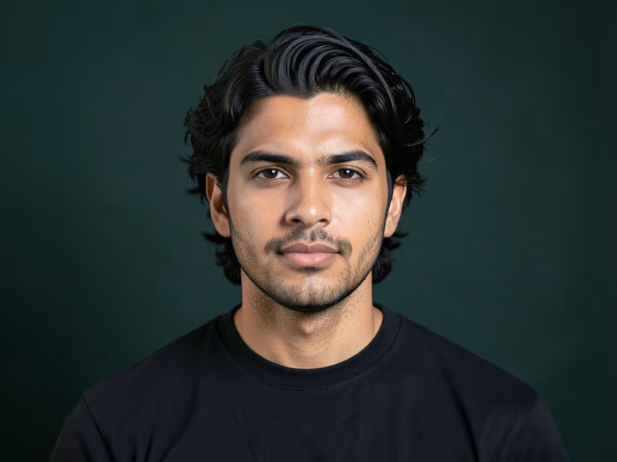 Man with a shoulder-length flow haircut swept back