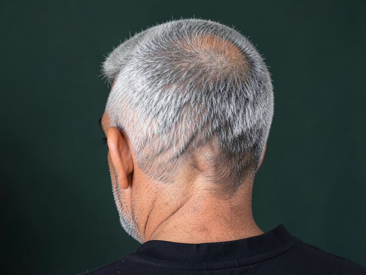Man with a gray french crop haircut