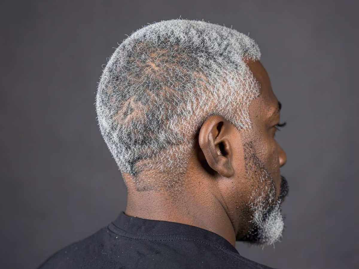 Man with a gray short afro haircut