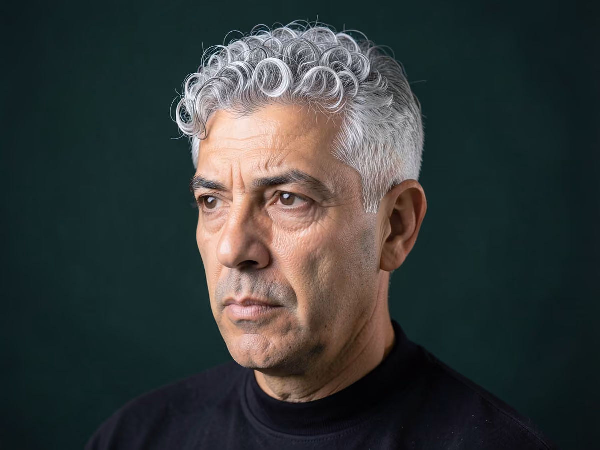 Man with a silver curly top
