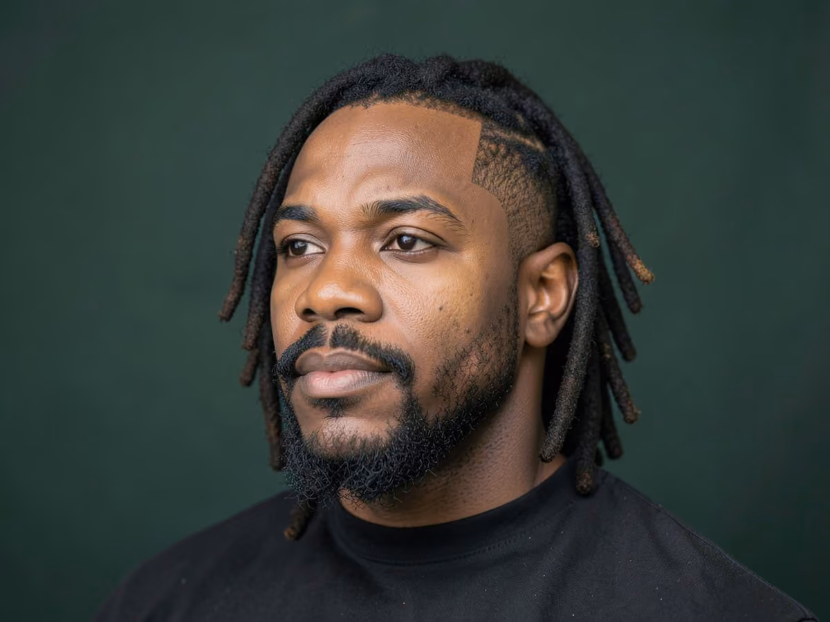 Man with a locs with van dyke haircut