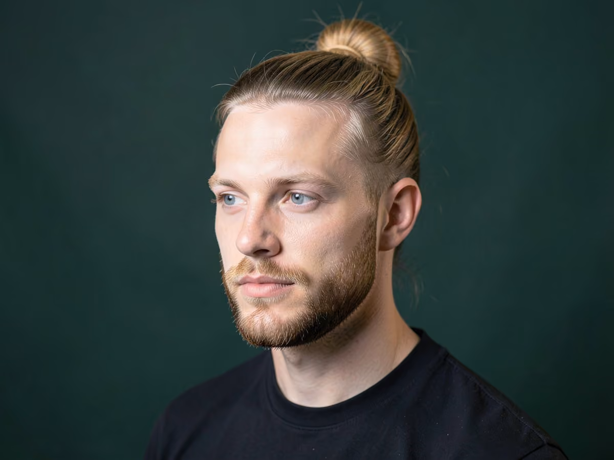 Man with a man bun with short boxed beard haircut