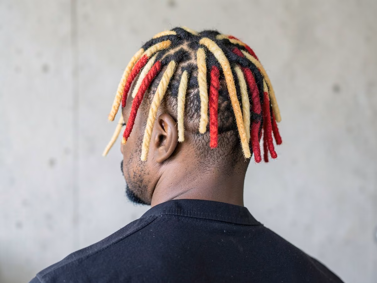 Man with a dyed tip locs haircut