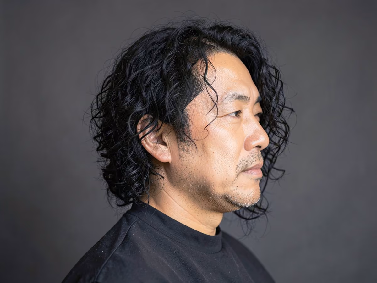 Man with a chin length curly hair