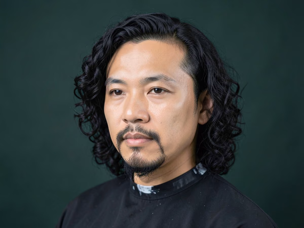 Man with a long curly hair with goatee