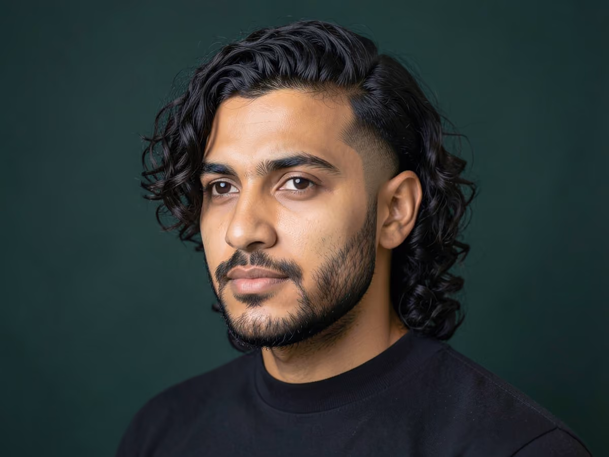 Man with a long curly hair with taper