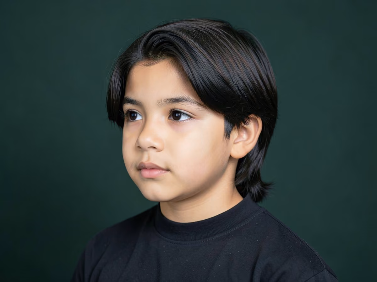 Boy with a boys long hair with low taper
