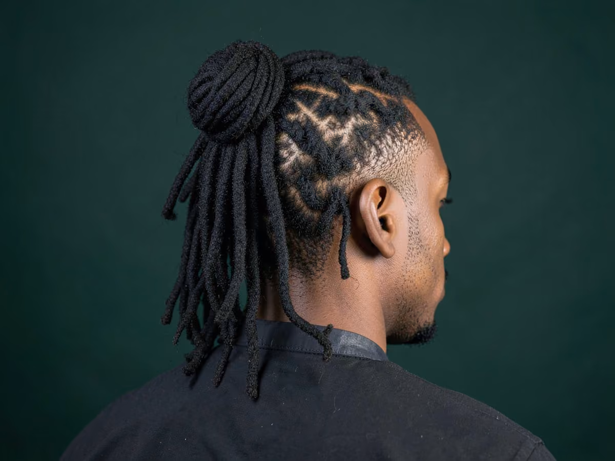 Man with a long locs half up haircut