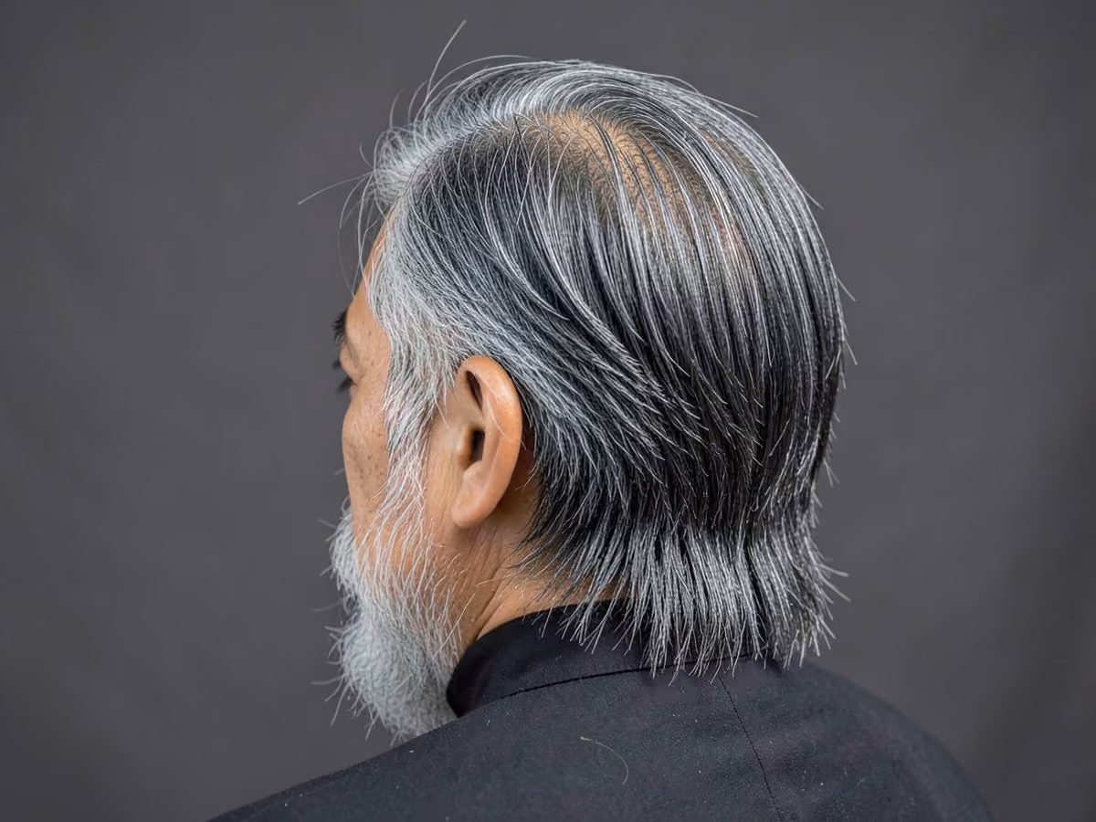 Man with an asian medium length hair