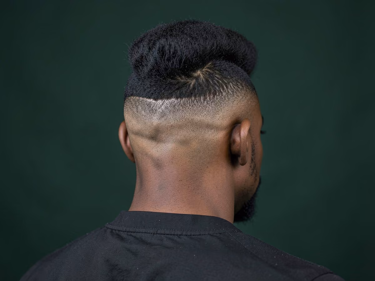 Man with a shaved sides afro mohawk