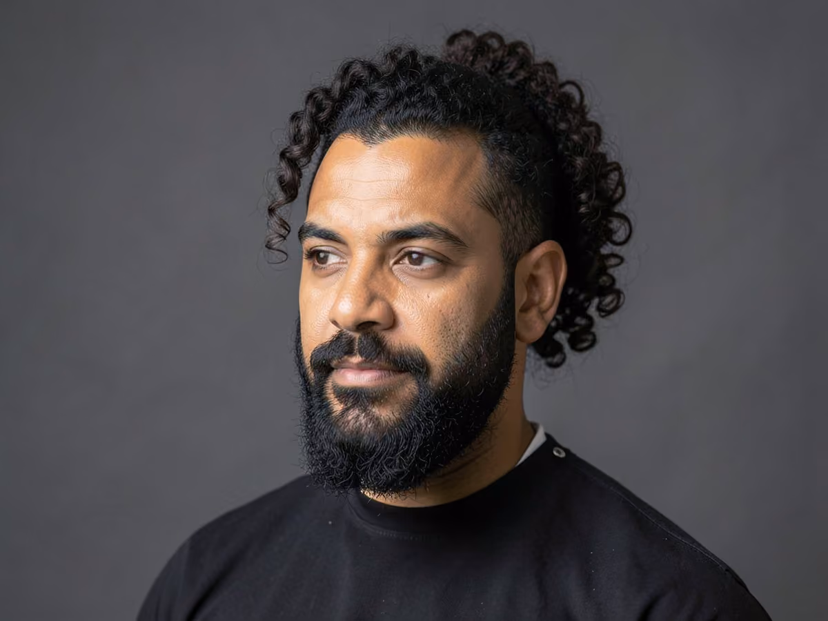 Man with a curly ponytail haircut