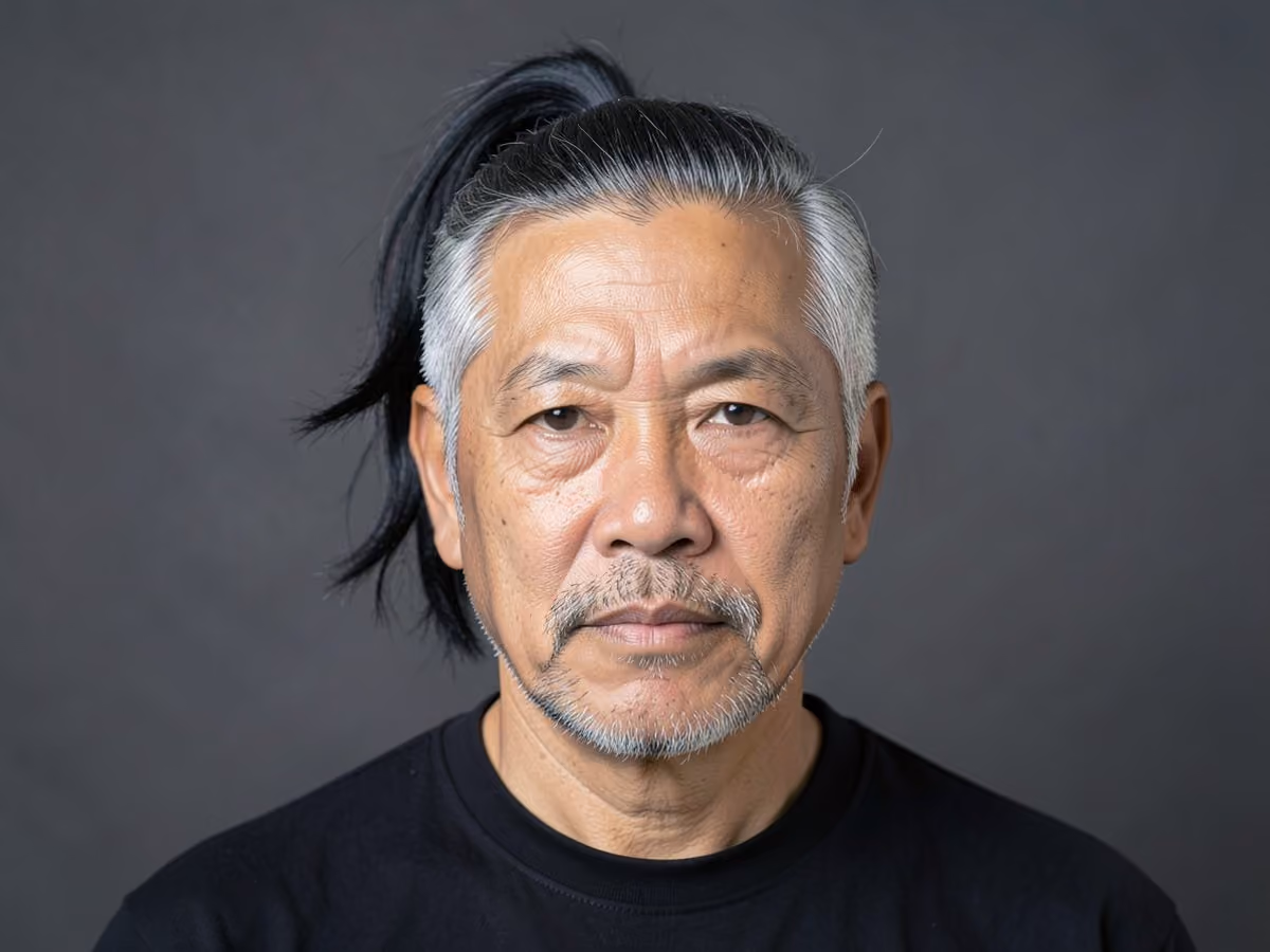 Man with a looped ponytail haircut