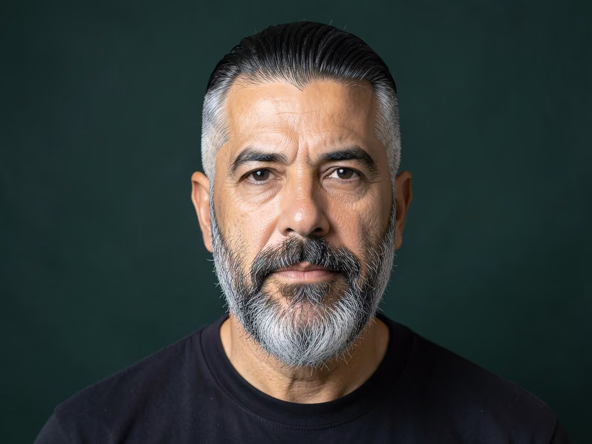 Man with a rockabilly slick back with mid fade
