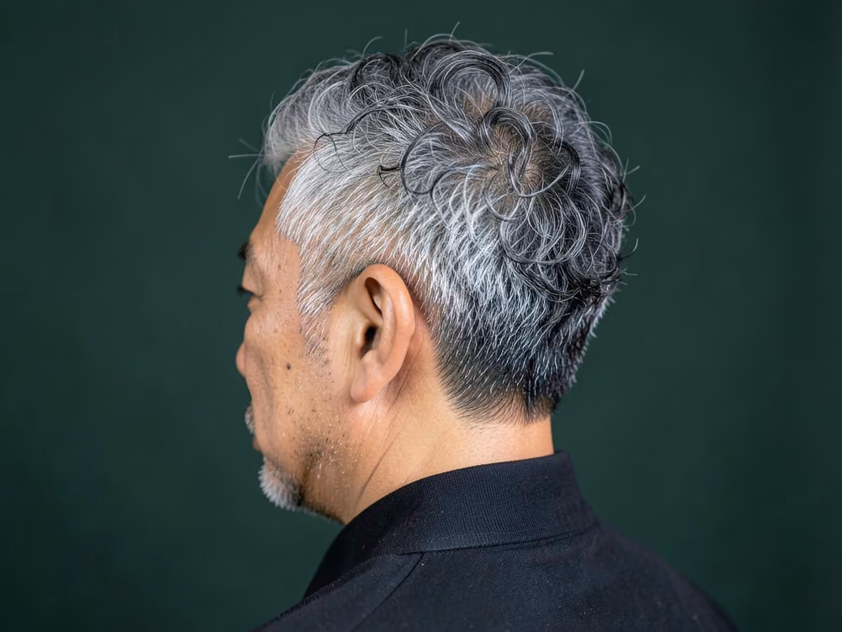 Man with a biracial short curly hair