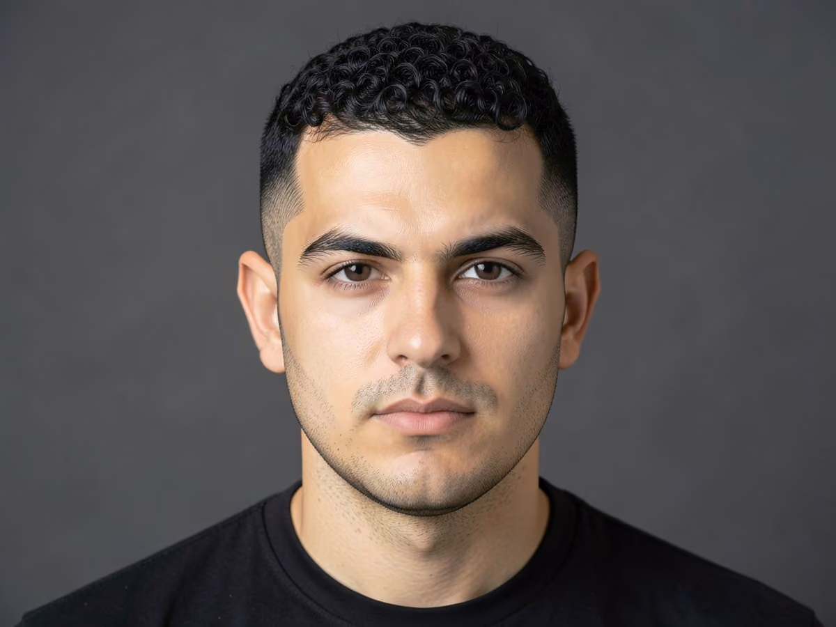 Man with a short curly crew cut