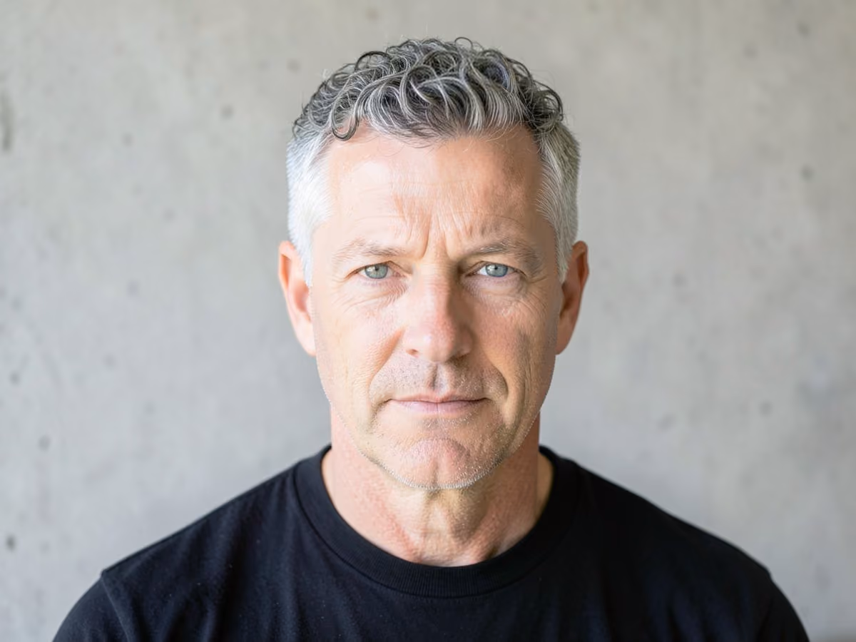 Man with a short curly gray hair