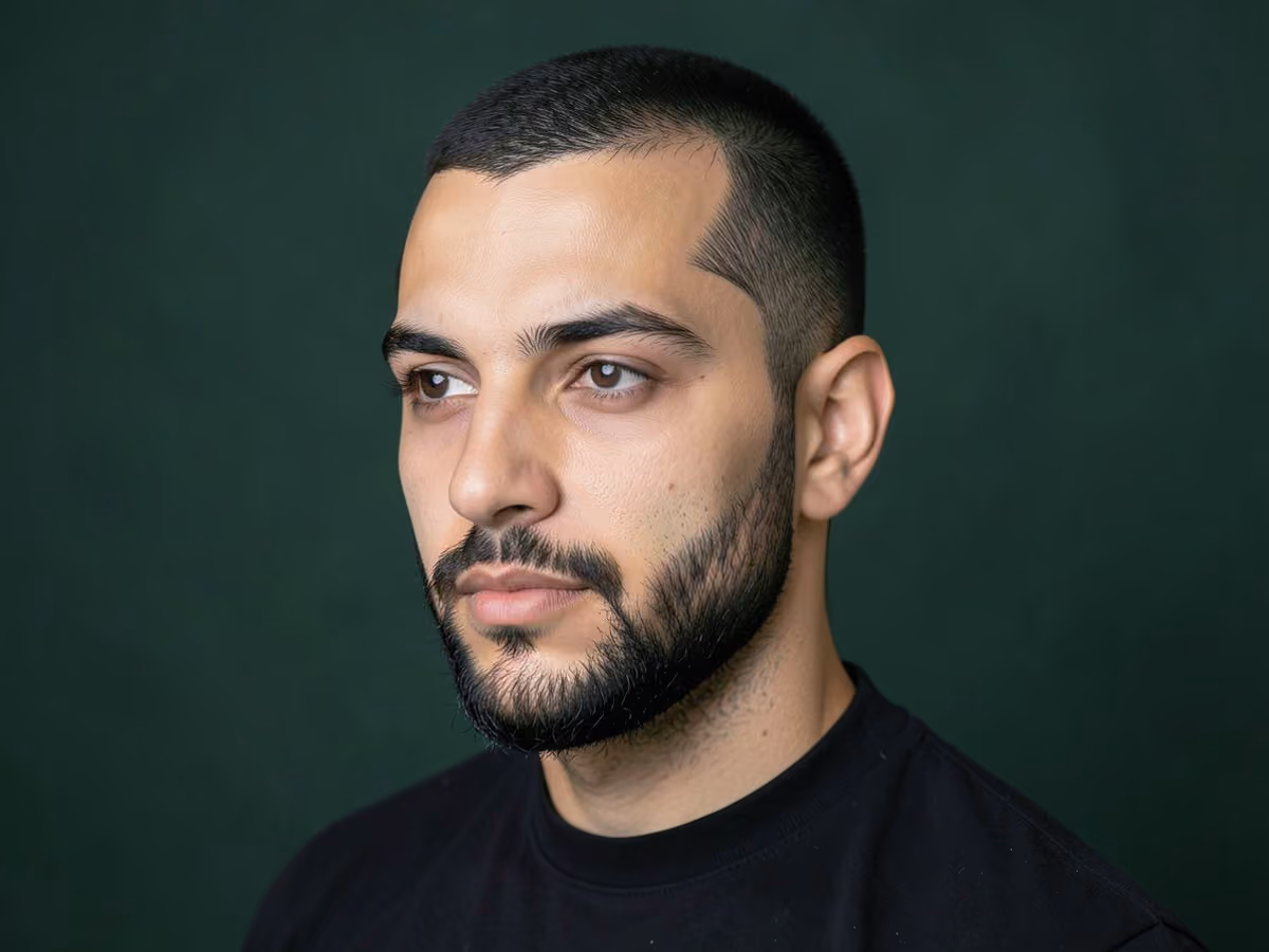 Man with a pointed sideburns haircut