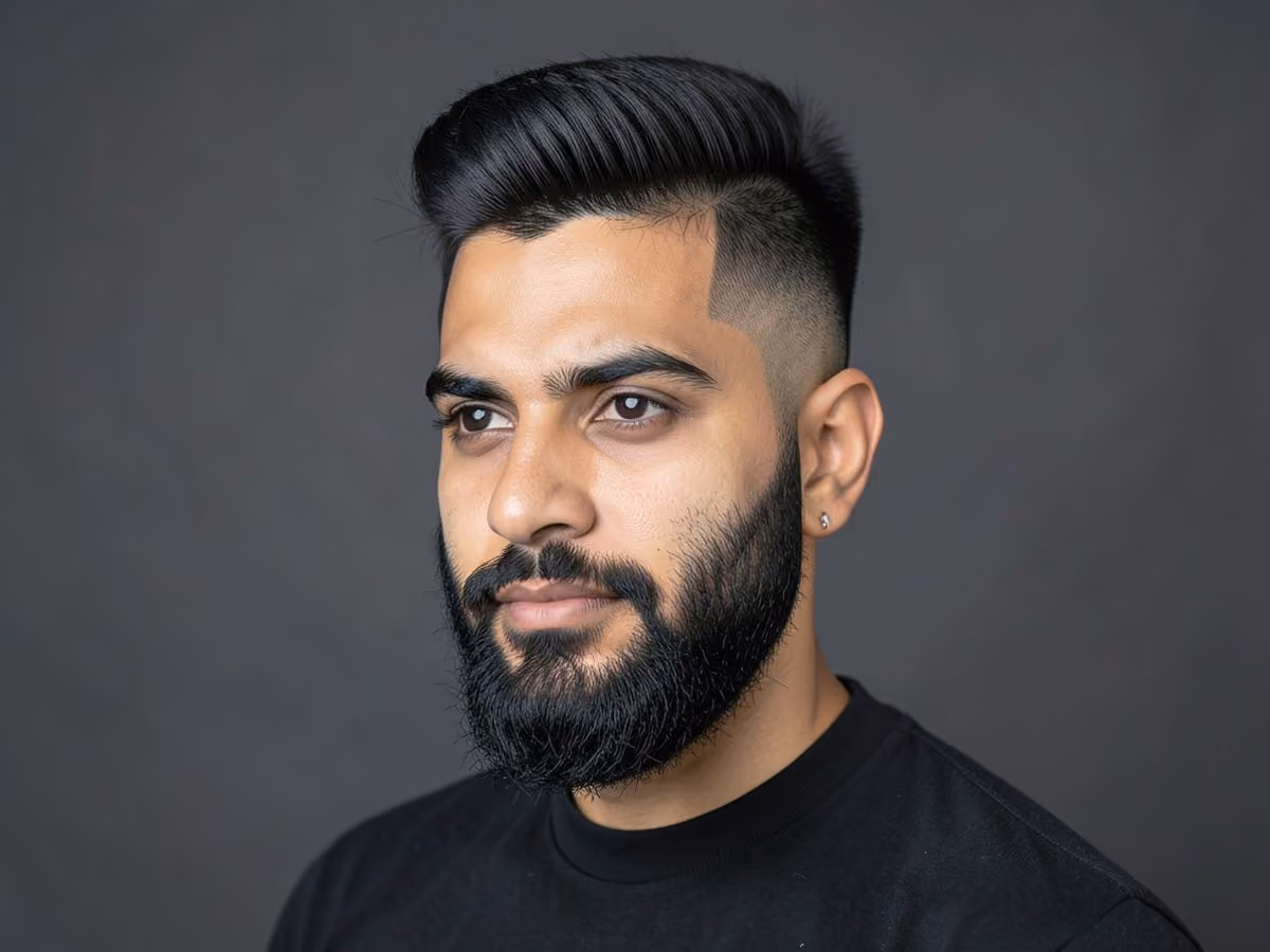 Man with a skin fade pompadour with beard