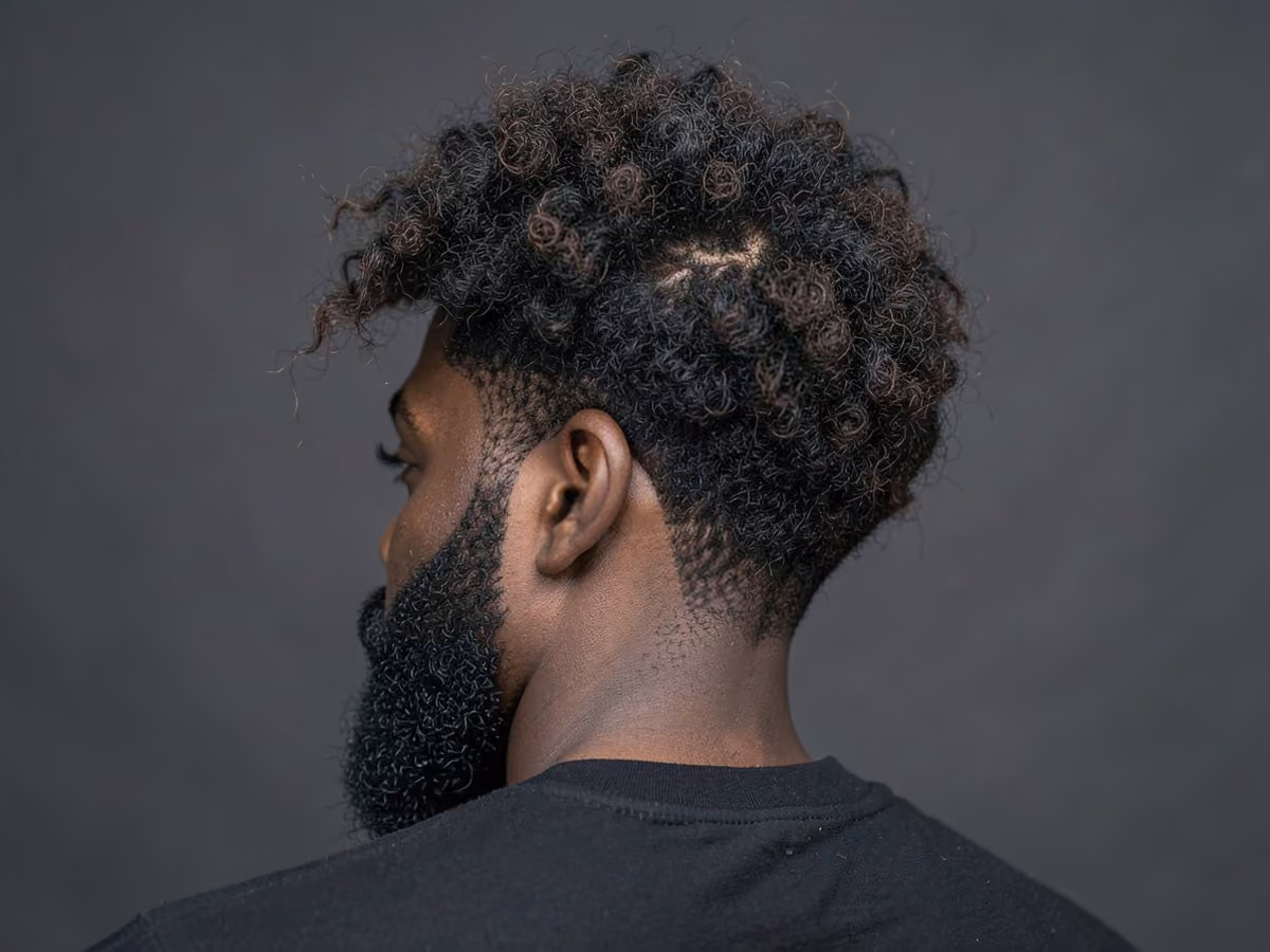 Man with a surfer afro haircut