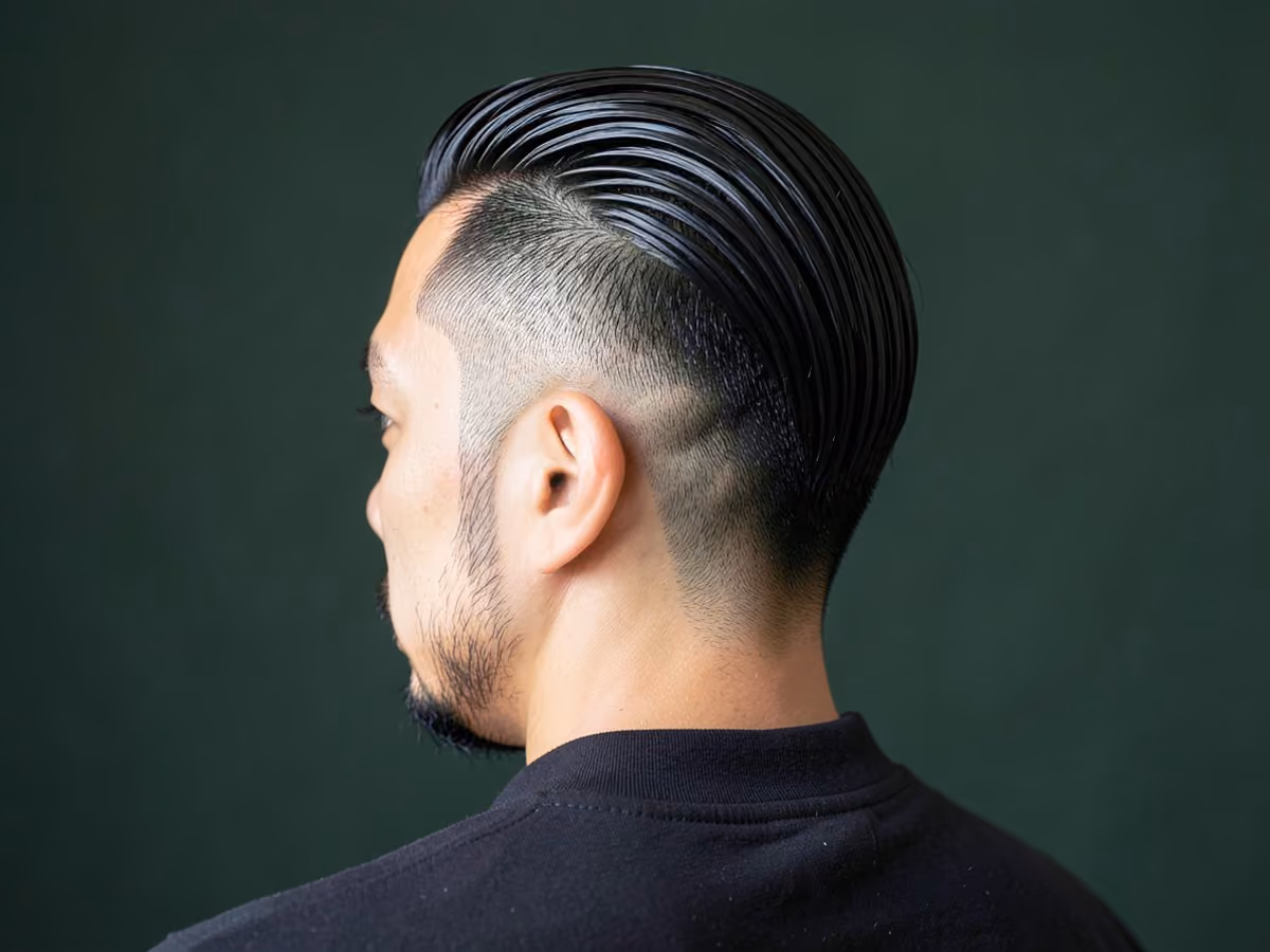 Man with a tape up with slick back