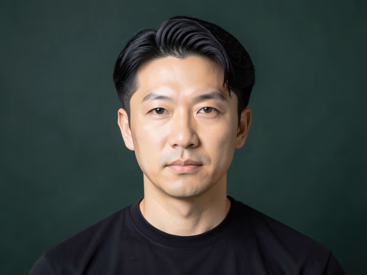 Man with a classic Korean two-block haircut, short sides and a longer top