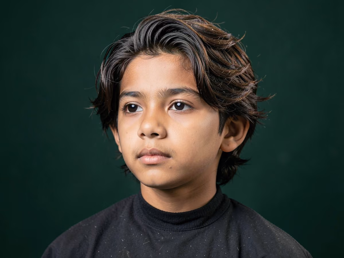 Boy with a shoulder length surfer cut