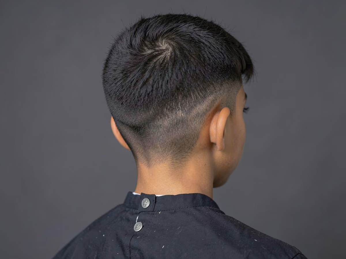 Boy with a textured fringe low taper haircut